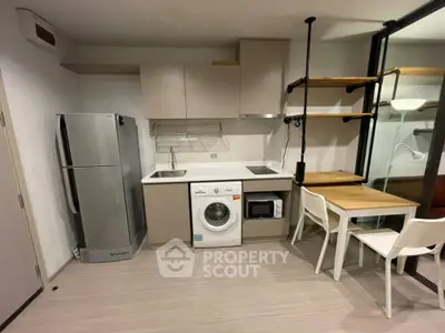 Modern compact kitchen with integrated appliances and dining area