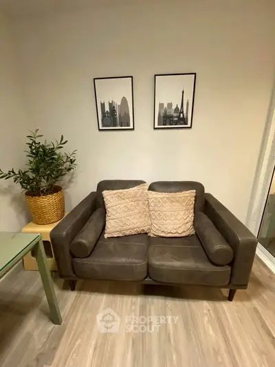 Cozy living room with stylish brown sofa and decorative wall art