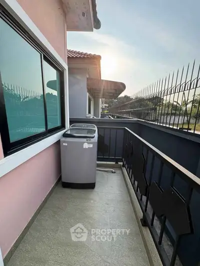 Charming balcony with washing machine and scenic view, perfect for urban living.