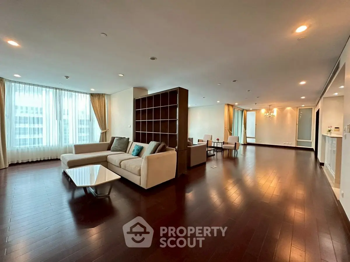 Spacious modern living room with elegant hardwood floors and large windows