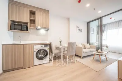 Modern open-plan living room with kitchen and cozy seating area