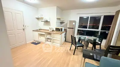 Modern open-layout kitchen and dining area with city view