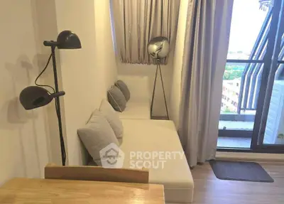 Cozy living room with modern decor and balcony view, perfect for relaxation and enjoying natural light.
