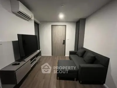 Modern living room with sleek furniture and large TV, perfect for relaxation and entertainment.