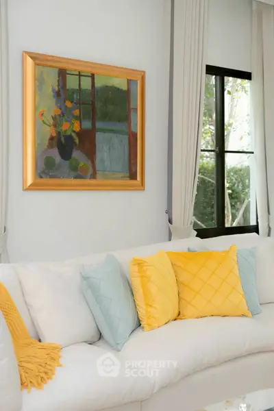 Elegant living room with stylish decor and large window view