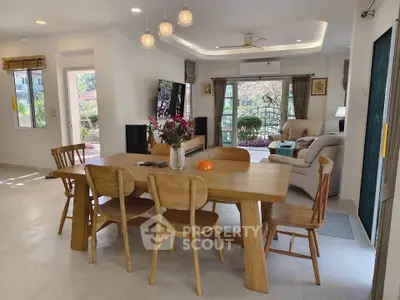 Spacious open-plan living and dining area with modern furnishings and natural light.