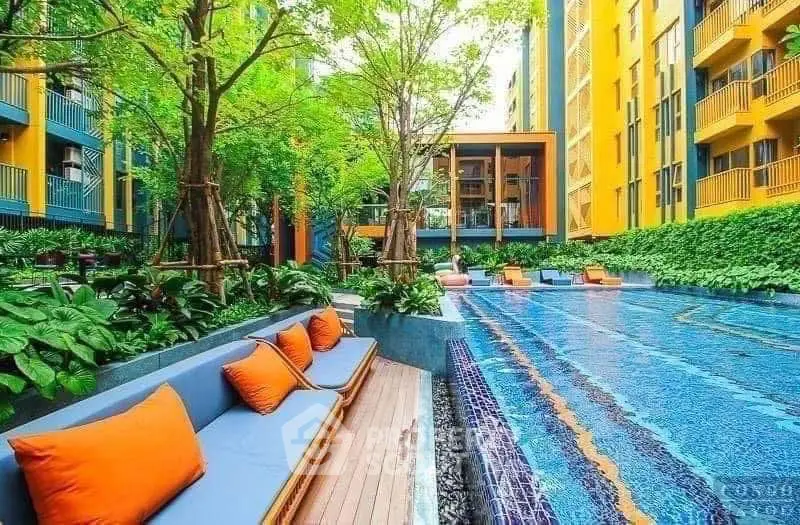 Luxurious apartment complex with vibrant poolside seating and lush greenery.