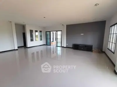 Spacious modern living room with large windows and sleek flooring