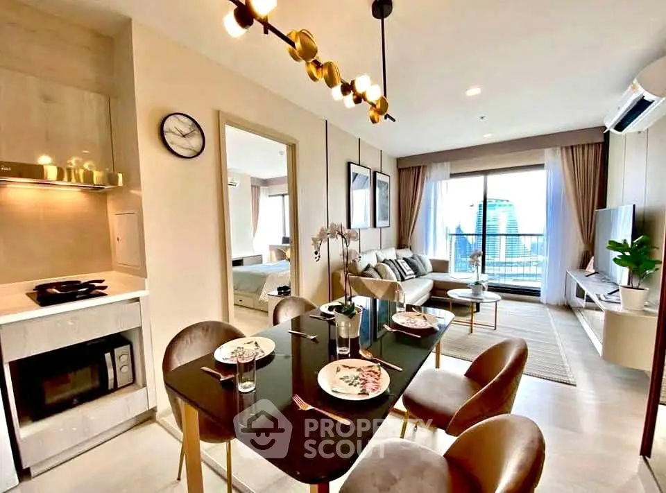 Modern open-plan living room with dining area and city view, featuring stylish decor and natural light.