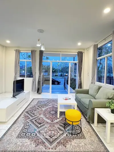 Spacious living room with modern decor and large windows for natural light.