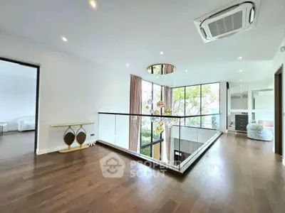 Spacious modern living area with elegant lighting and large windows