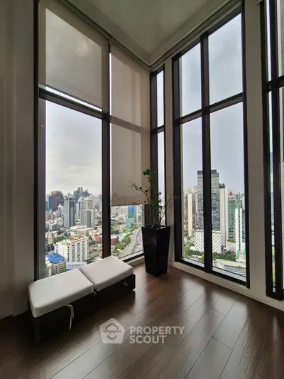 Stunning corner unit with floor-to-ceiling windows offering panoramic city views.
