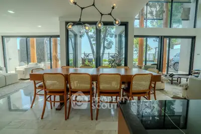 Luxurious dining area with modern chandelier and large windows offering stunning views