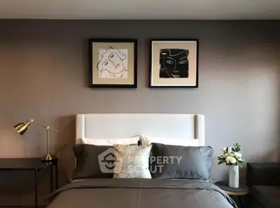 Stylish bedroom with modern decor and elegant artwork above the bed