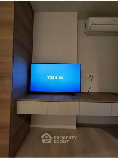 Modern living room with Toshiba TV and sleek air conditioning unit