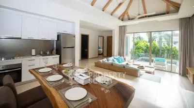 Luxurious open-plan living room with modern kitchen and pool view, perfect for entertaining.