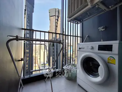 Modern high-rise balcony with washing machine and city view, perfect for urban living.
