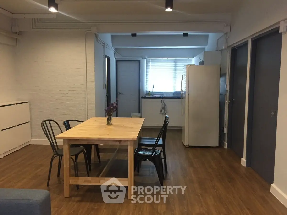 Spacious kitchen with wooden dining table and modern appliances