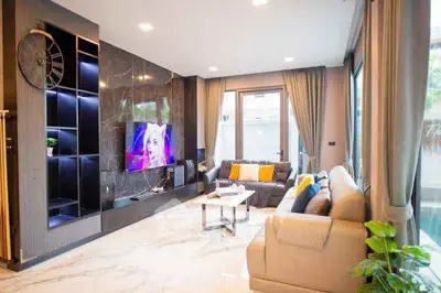 Luxurious modern living room with elegant decor and large windows.