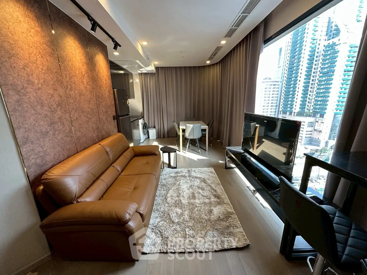 Modern living room with leather sofa and city view, featuring stylish decor and natural light.