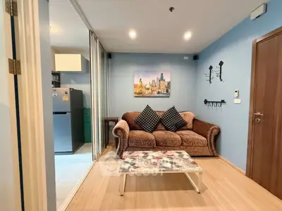 Cozy living room with plush sofa and modern decor in a stylish apartment.