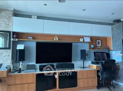 Modern living room with entertainment center and workspace setup