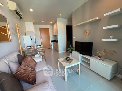 Modern living room with sleek furniture and open kitchen layout