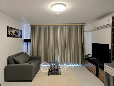 Modern living room with sleek furniture and large window curtains