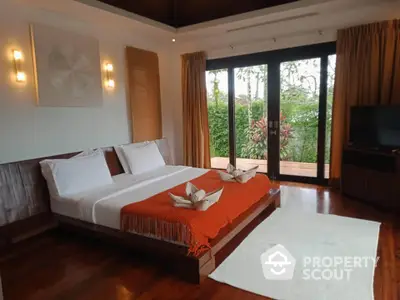 Luxurious bedroom with elegant decor and garden view, featuring a cozy bed and stylish lighting.