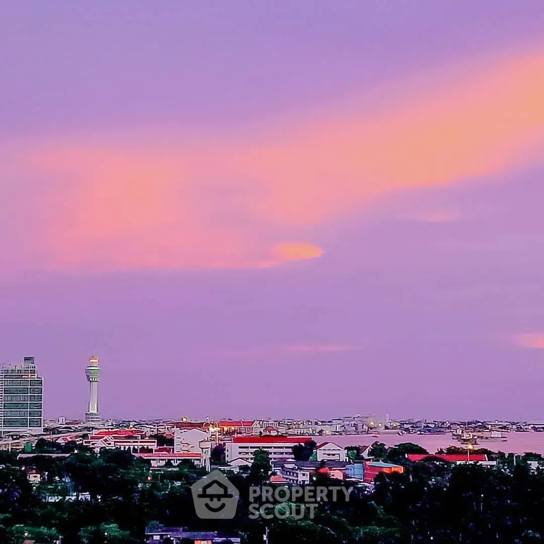 Stunning cityscape view with vibrant sunset sky and iconic tower