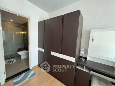 Modern bedroom with wardrobe and ensuite bathroom in stylish apartment