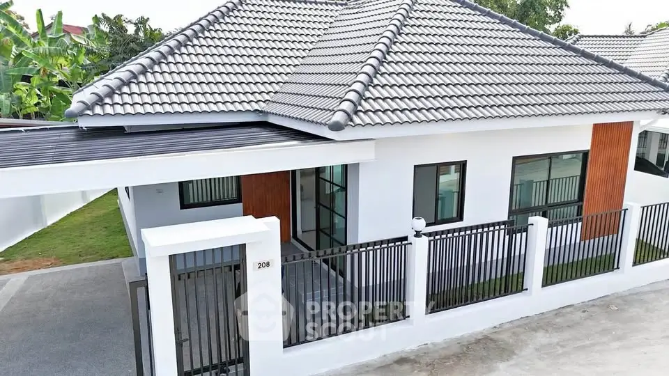 Modern single-story house with tiled roof and gated entrance