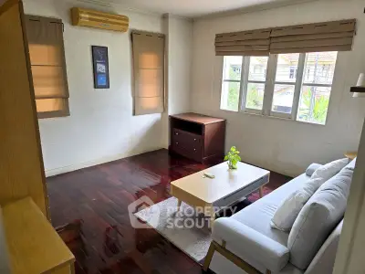 Cozy living room with hardwood floors and natural light