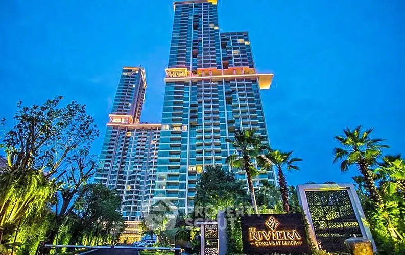 Luxurious high-rise condominium with stunning architecture and lush landscaping at dusk.