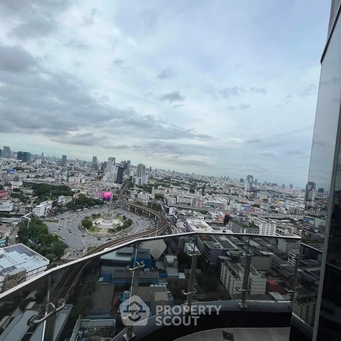 Stunning cityscape view from a high-rise balcony, showcasing urban skyline and expansive horizon.