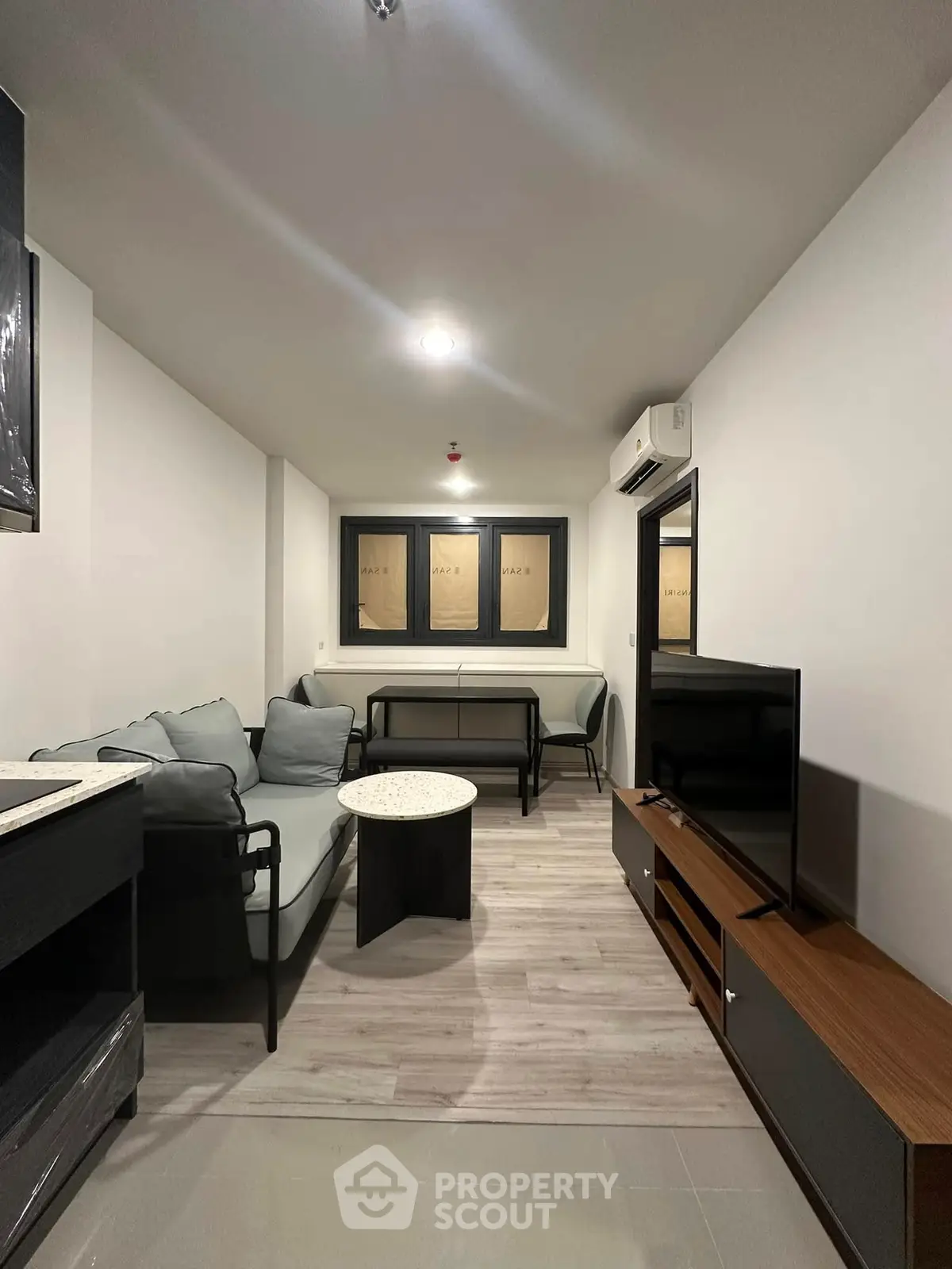 Modern living room with sleek furniture and neutral tones, perfect for relaxation and entertainment.
