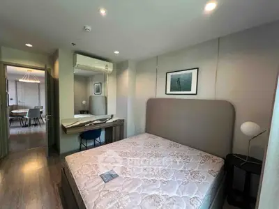 Modern bedroom with stylish decor and natural light, featuring a cozy bed and elegant furnishings.