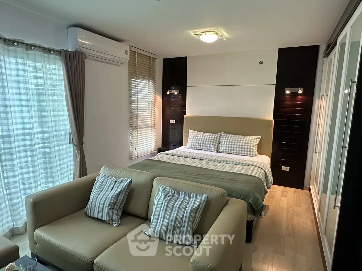 Stylish bedroom with cozy seating area and modern decor