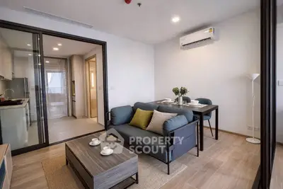 Modern living room with stylish furniture and open kitchen layout in a contemporary apartment.