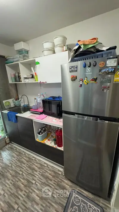 Modern kitchen with sleek stainless steel fridge and open shelving