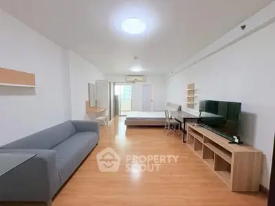 Spacious studio apartment with modern furnishings and wooden flooring