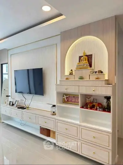 Modern living room with built-in TV unit and decorative shelves