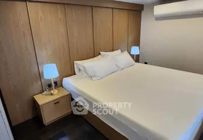 Cozy bedroom with modern wooden paneling and ambient lighting