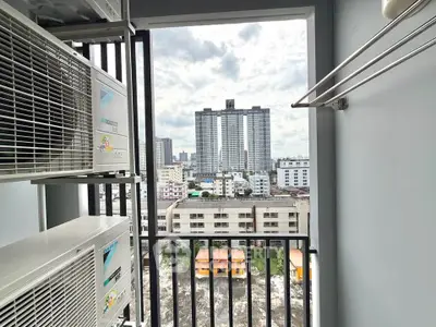 Urban balcony with city view and air conditioning units, perfect for modern living.