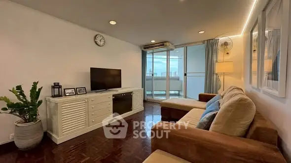 Spacious living room with modern decor and balcony view in a stylish apartment.