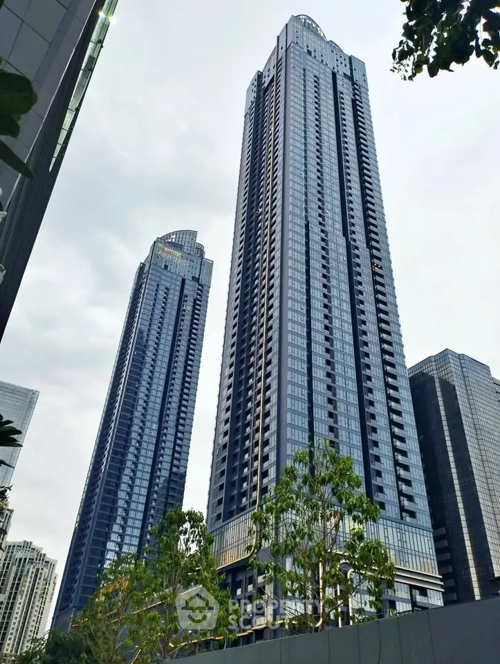Stunning skyscraper towers in urban skyline with modern architectural design and lush greenery.