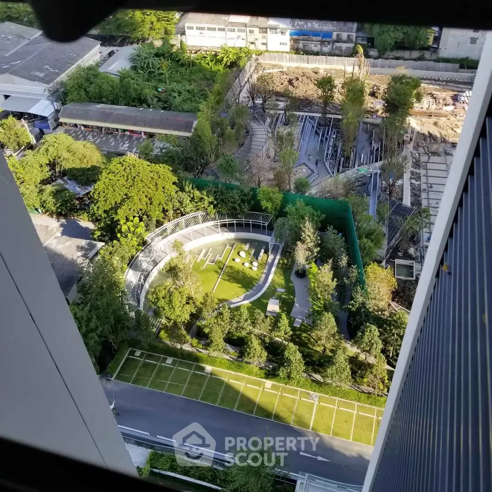 Stunning aerial view of modern garden with lush greenery and unique circular design in urban setting.