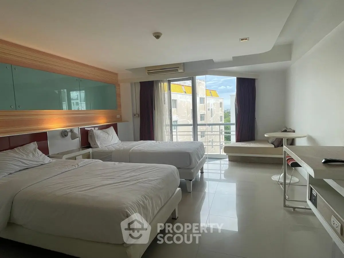 Modern twin bedroom with balcony and sleek furnishings