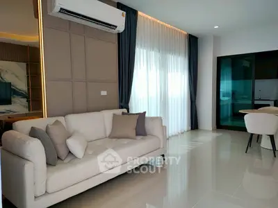 Modern living room with elegant sofa and large windows