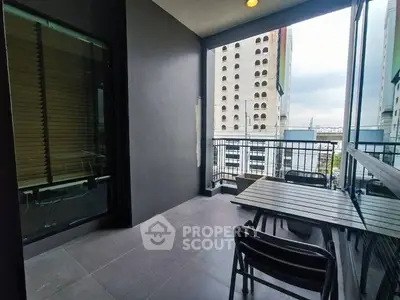 Spacious balcony with city view and modern outdoor furniture.